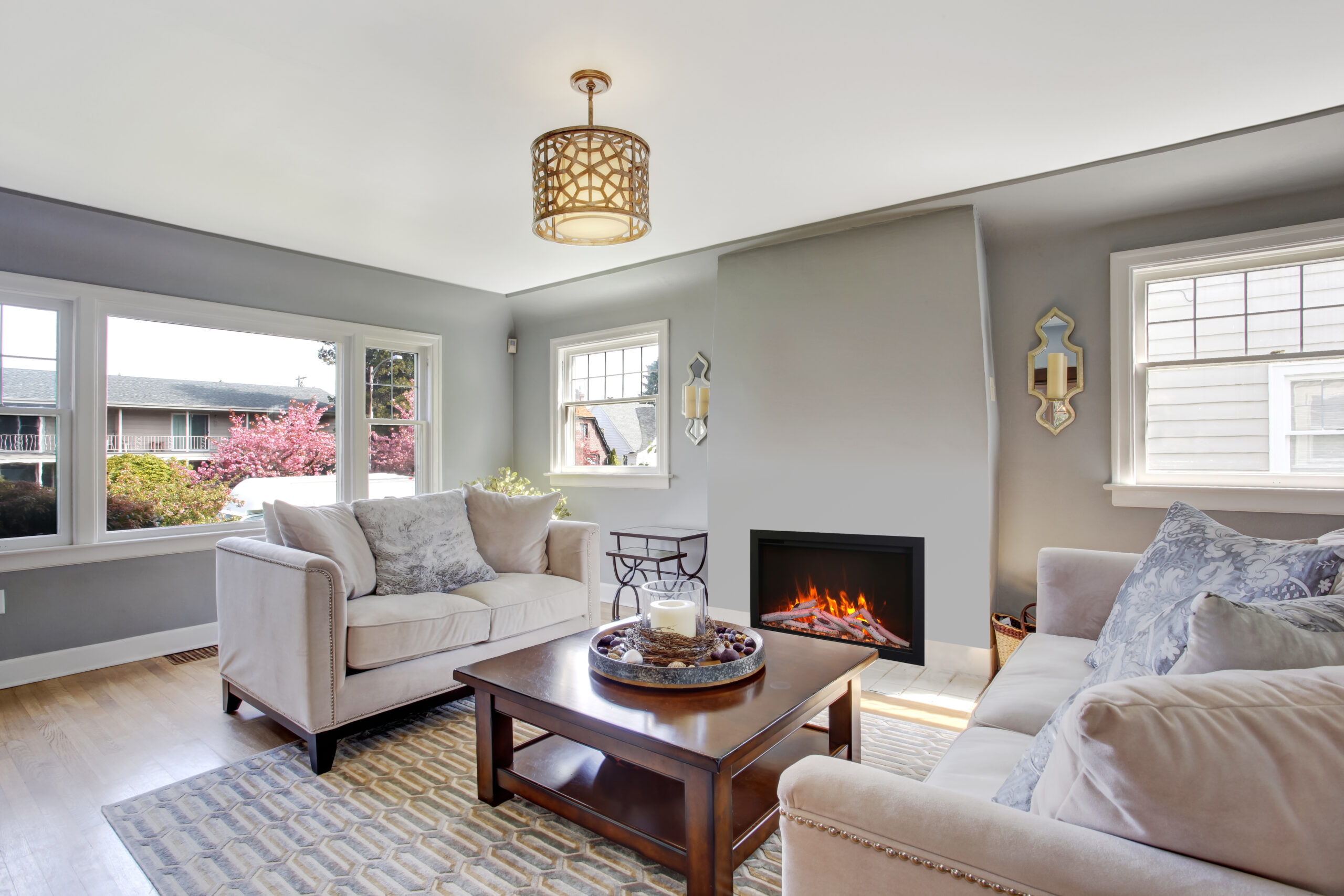 Light grey living room with white sofas and fireplace